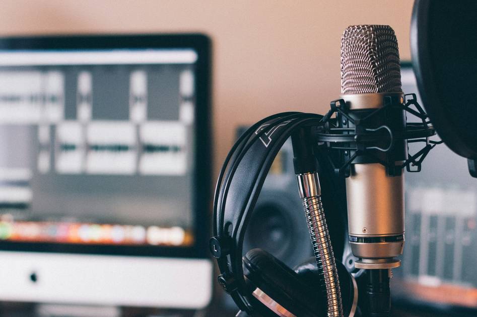 Cozy studio setup with podcasting gear and notebooks